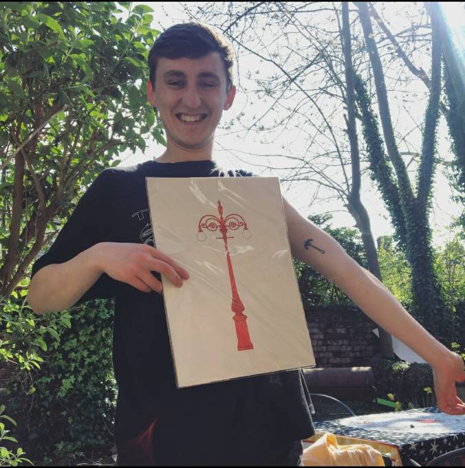 Image 10: Adam showing his arm tattoo of the Hyde Park lamppost.